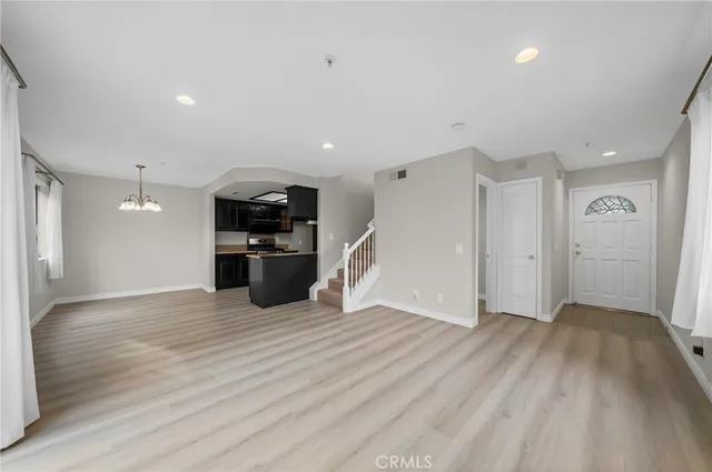 a view of a kitchen with a sink and a refrigerator