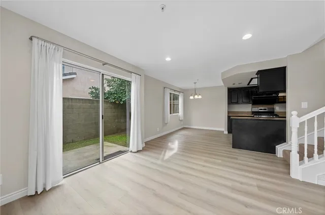 a view of kitchen with microwave and refrigerator