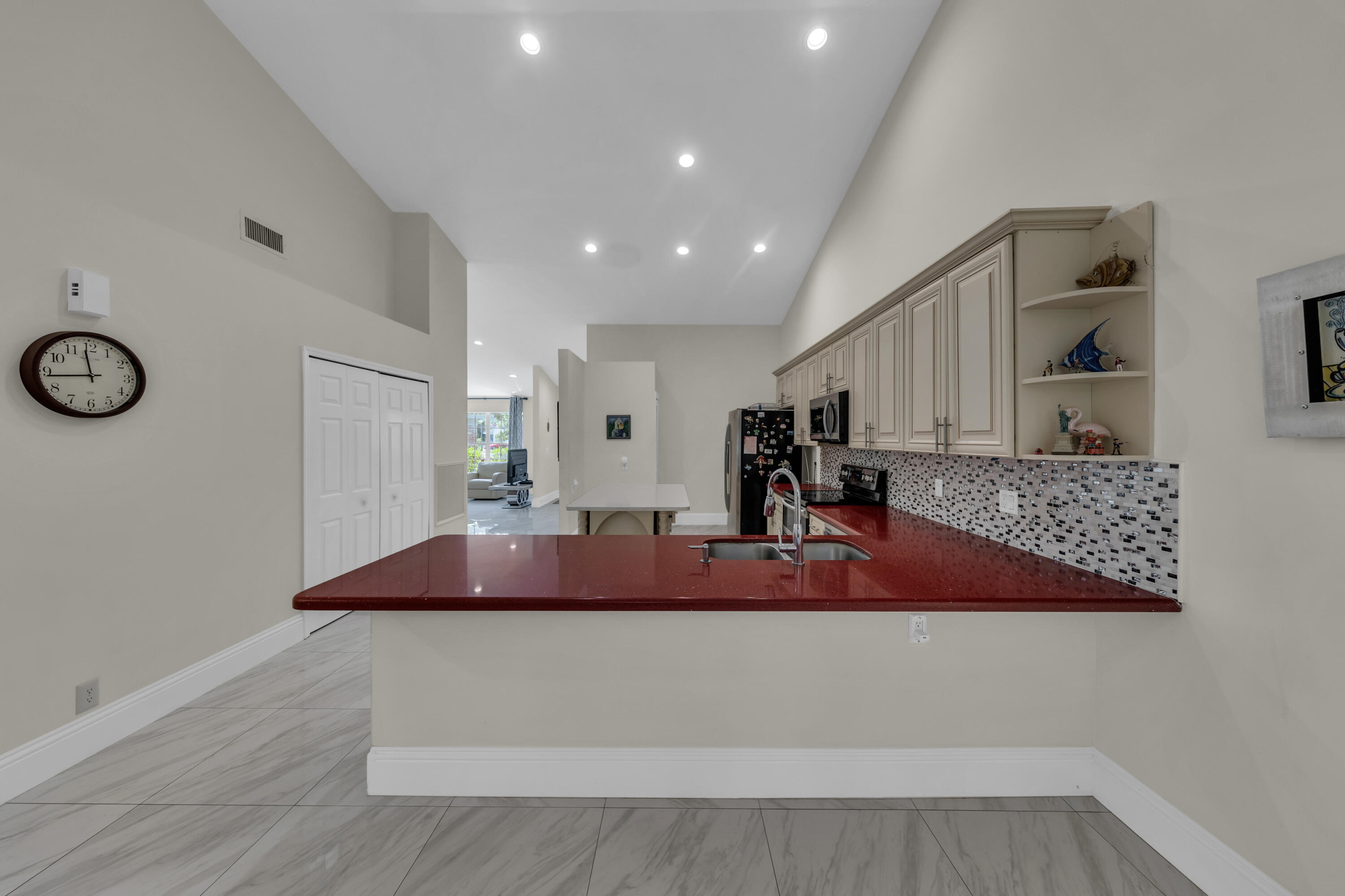 19623 Back 9 Drive Boca Raton, FL 33498 - Photo 11 of 24 a kitchen with stainless steel appliances granite countertop a sink and a refrigerator