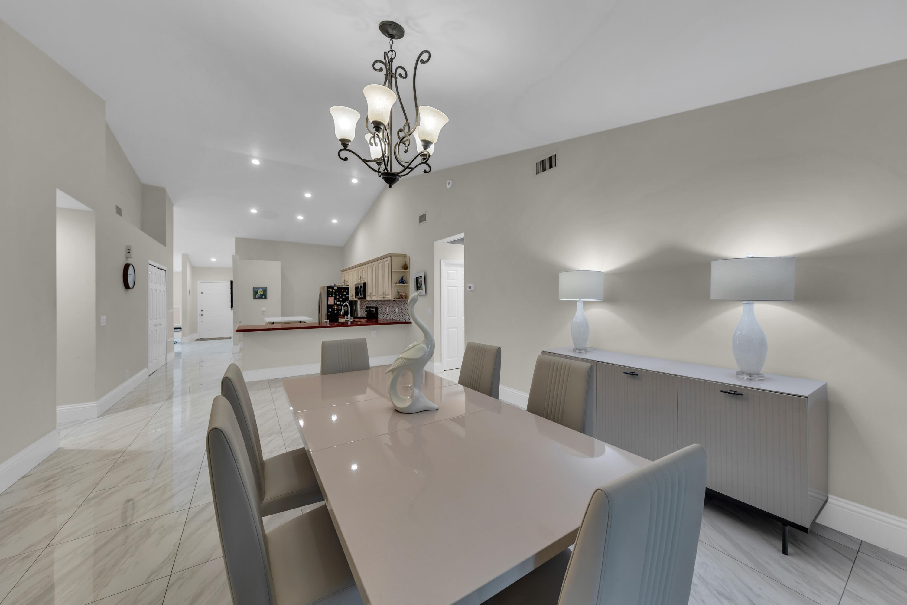 19623 Back 9 Drive Boca Raton, FL 33498 - Photo 18 of 24 a view of a dining room with furniture and chandelier