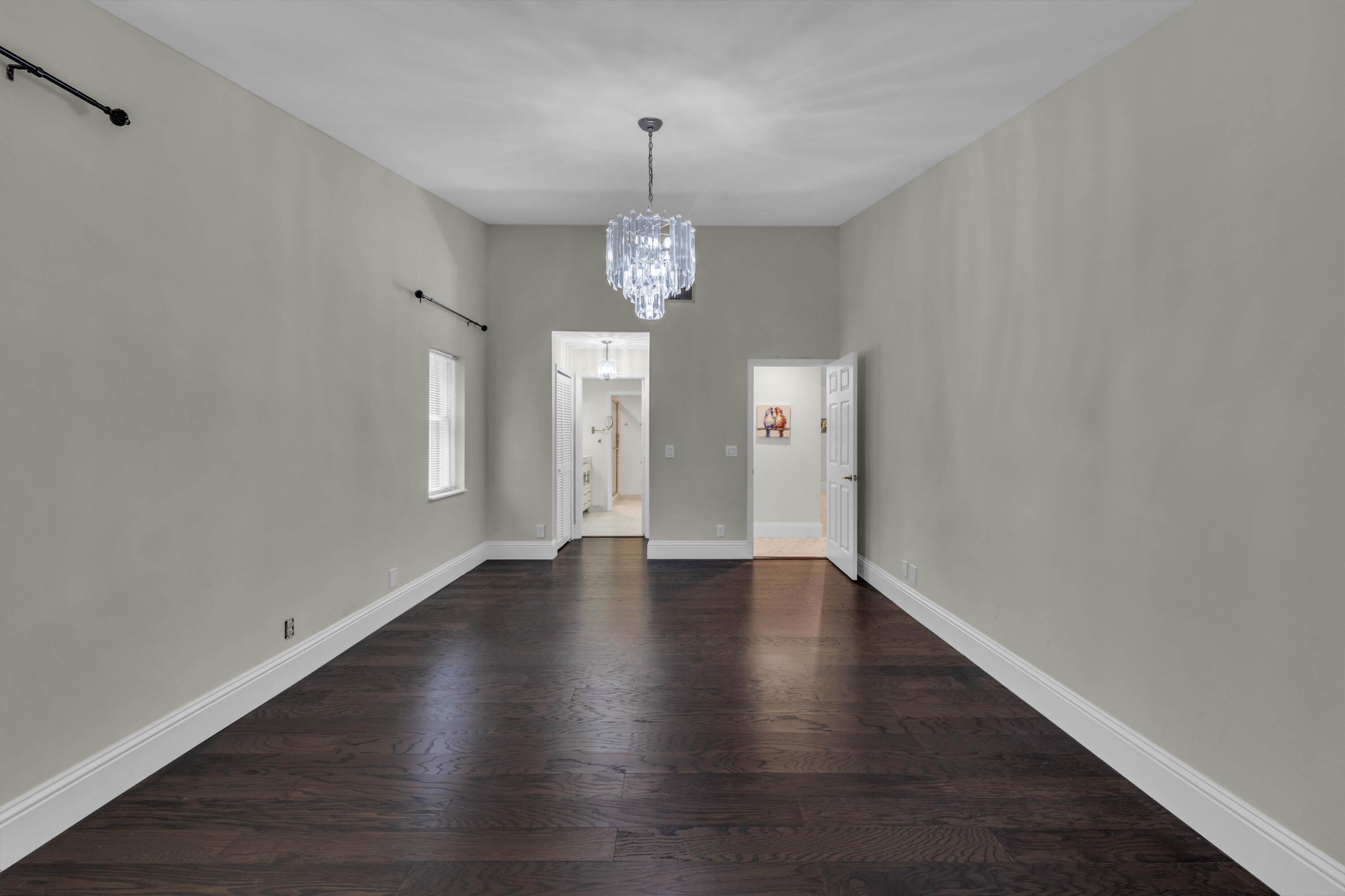 19623 Back 9 Drive Boca Raton, FL 33498 - Photo 21 of 24 a view of an empty room with wooden floor and windows