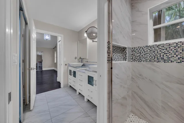 a bathroom with a double vanity sink and mirror
