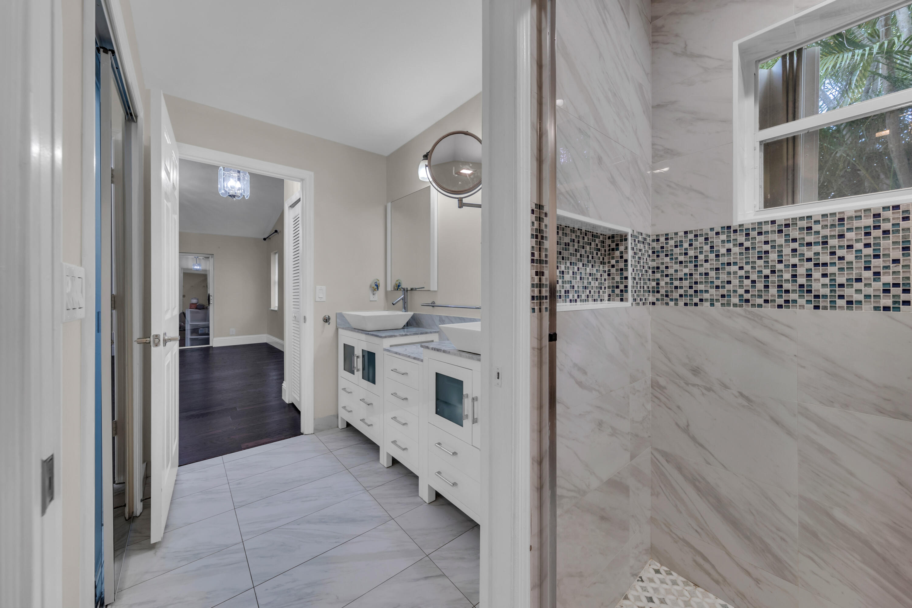 19623 Back 9 Drive Boca Raton, FL 33498 - Photo 24 of 24 a bathroom with a double vanity sink and mirror