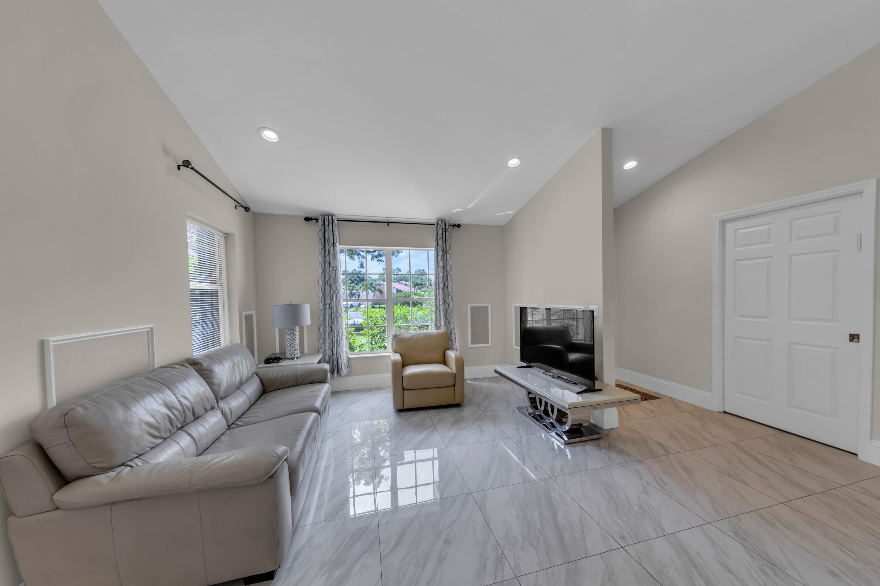 19623 Back 9 Drive Boca Raton, FL 33498 - Photo 4 of 24 a living room with furniture window and a flat screen tv