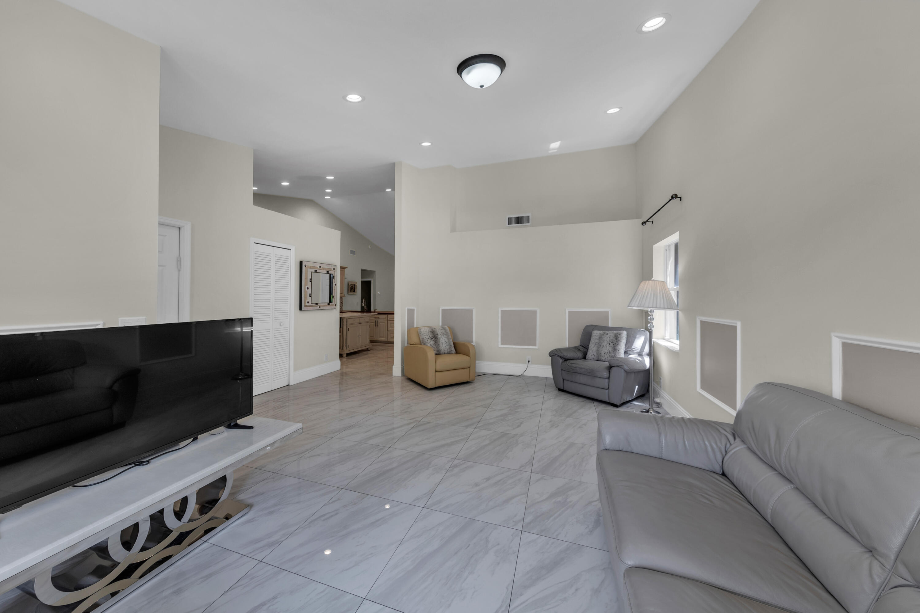 19623 Back 9 Drive Boca Raton, FL 33498 - Photo 5 of 24 a living room with furniture and a flat screen tv
