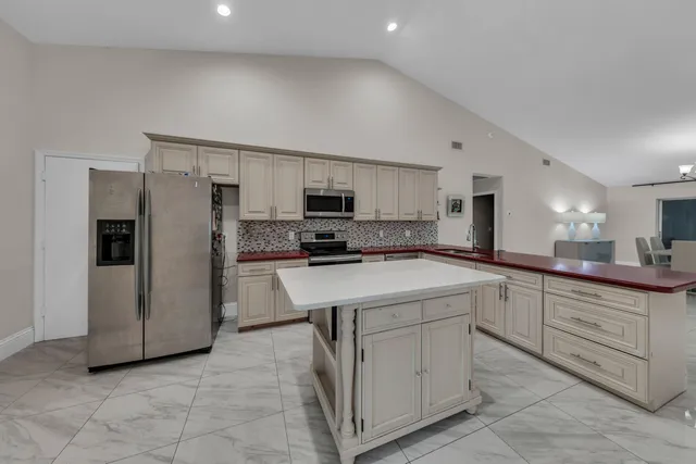 a kitchen with cabinets stainless steel appliances and a counter space