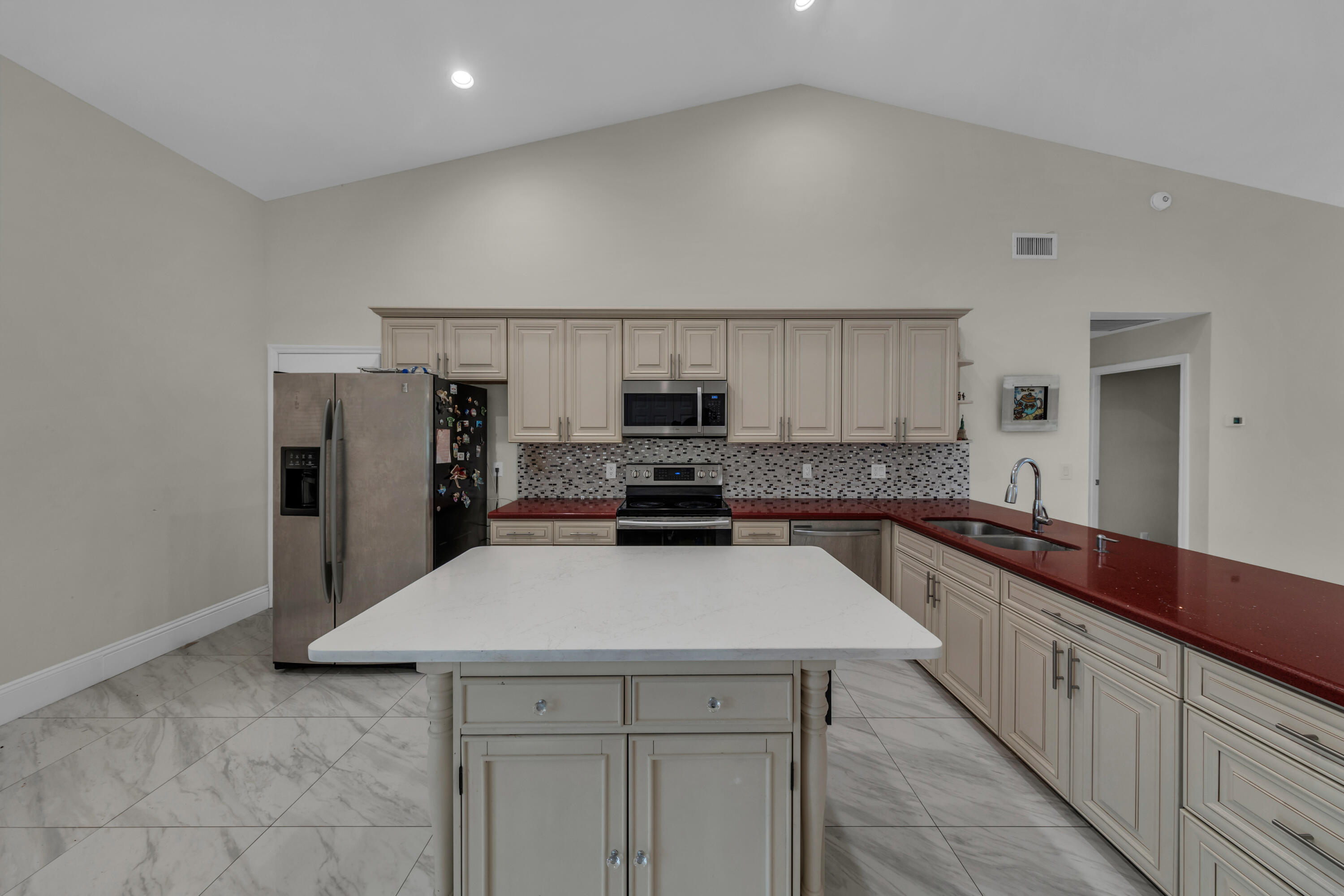 19623 Back 9 Drive Boca Raton, FL 33498 - Photo 7 of 24 a kitchen with granite countertop a sink stove and refrigerator