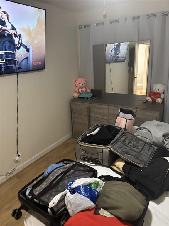 2200 East Trinity Mills Road, Unit 715 Carrollton, TX 75006 - Photo 15 of 31 a room with furniture and wooden floor