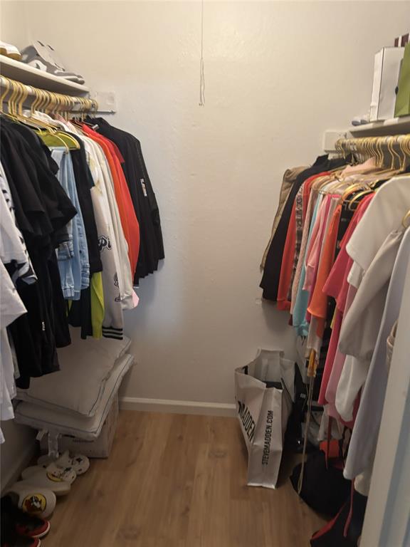 2200 East Trinity Mills Road, Unit 715 Carrollton, TX 75006 - Photo 17 of 31 a view of walk in closet with clothes and shoes