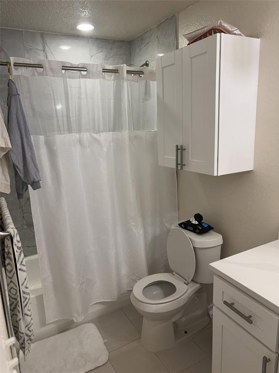 2200 East Trinity Mills Road, Unit 715 Carrollton, TX 75006 - Photo 18 of 31 a bathroom with a toilet a sink and a shower