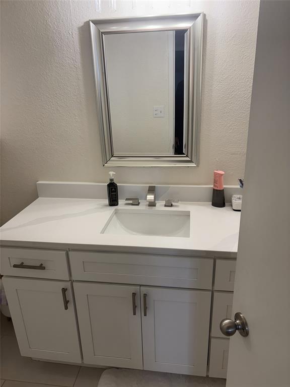 2200 East Trinity Mills Road, Unit 715 Carrollton, TX 75006 - Photo 19 of 31 a bathroom with a sink and a mirror