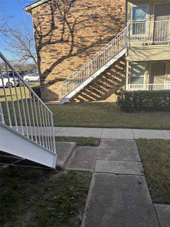 2200 East Trinity Mills Road, Unit 715 Carrollton, TX 75006 - Photo 30 of 31 a view of a yard with a bench