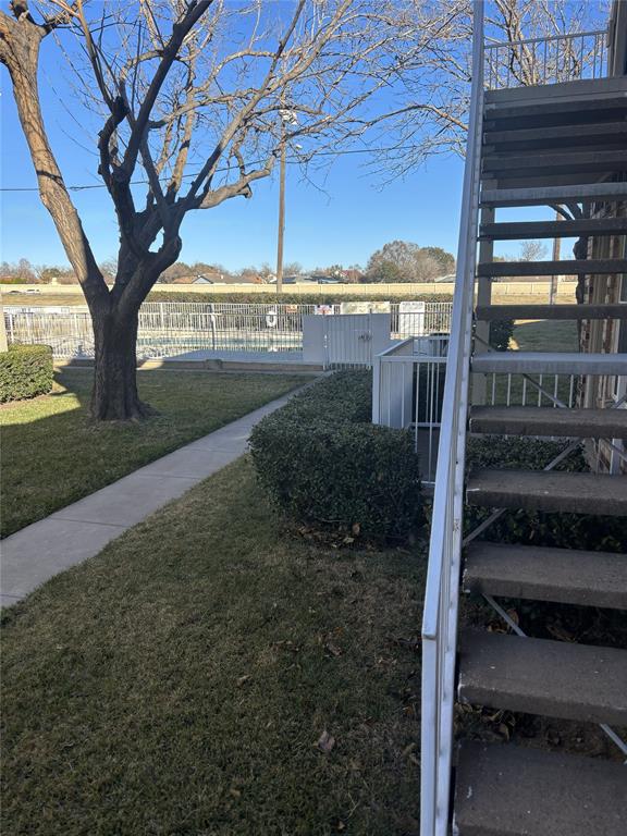 2200 East Trinity Mills Road, Unit 715 Carrollton, TX 75006 - Photo 31 of 31 a view of a porch with a yard