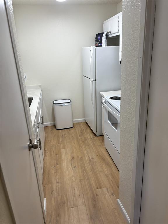 2200 East Trinity Mills Road, Unit 715 Carrollton, TX 75006 - Photo 9 of 31 a room with a wooden floor and white walls