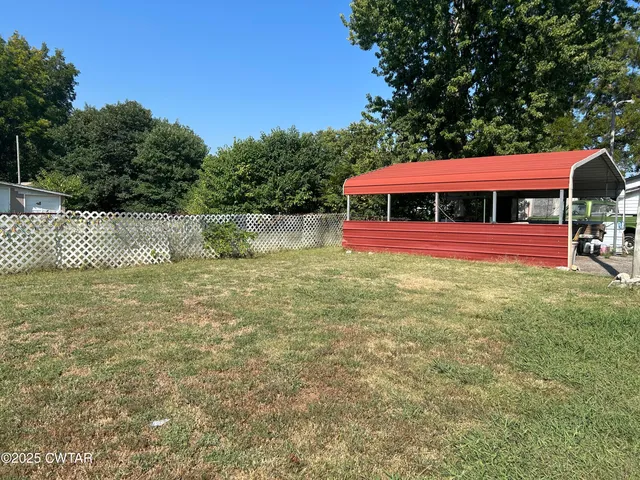 a view of a house with a yard porch and sitting area