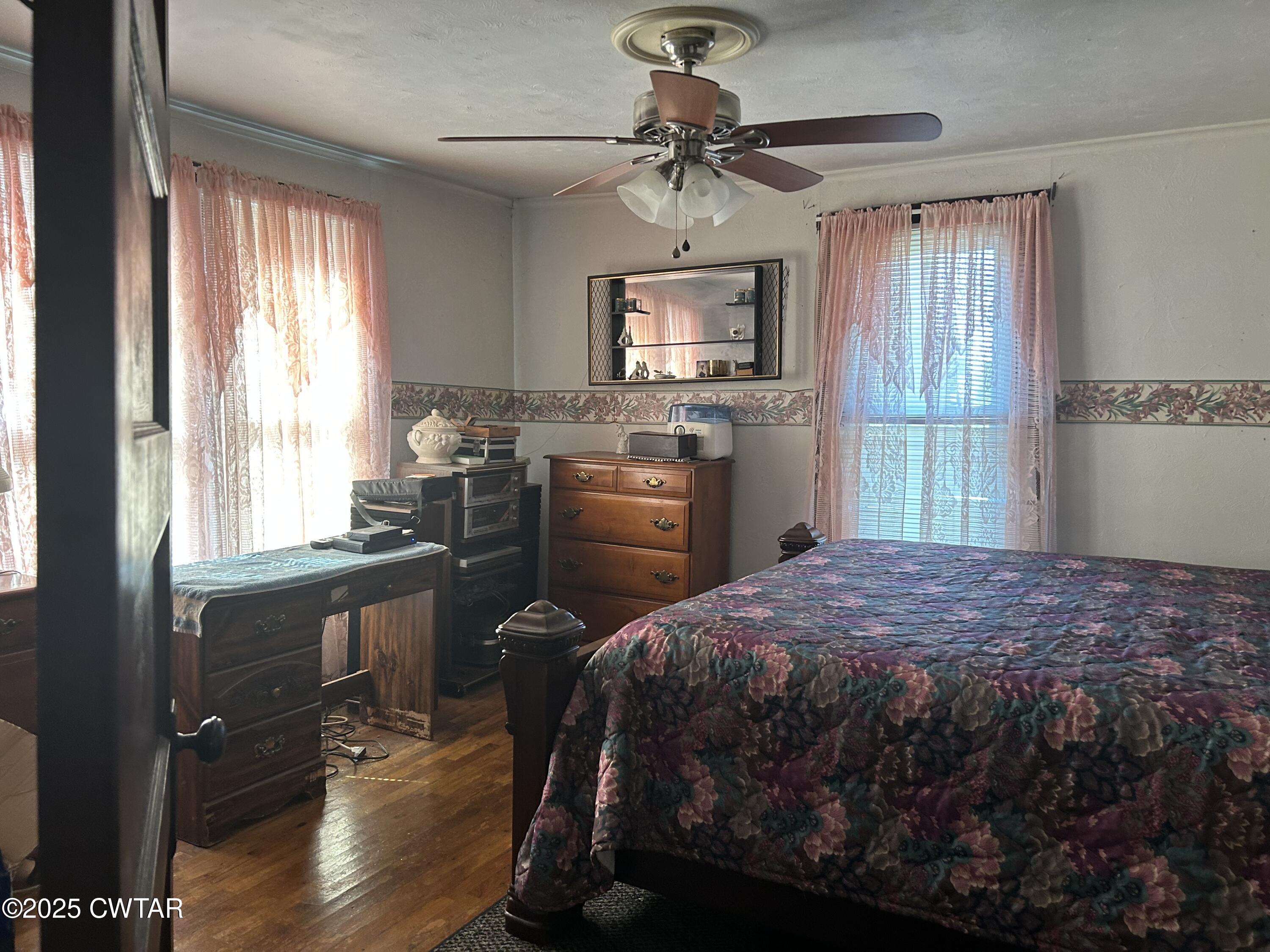 3084 West Jackson Street Milan, TN 38358 - Photo 3 of 11 a bedroom with a bed and a chandelier