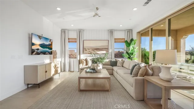 a living room with furniture and a potted plant