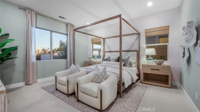 a bedroom with a large bed and a chandelier