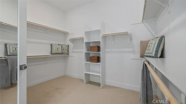 a spacious bedroom with a bed and a chandelier