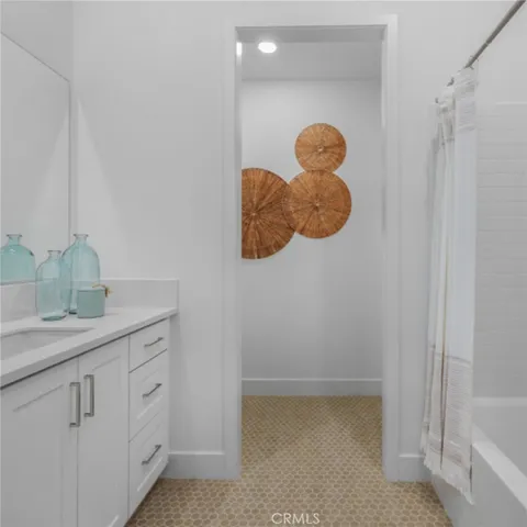 a kitchen with white cabinets and sink