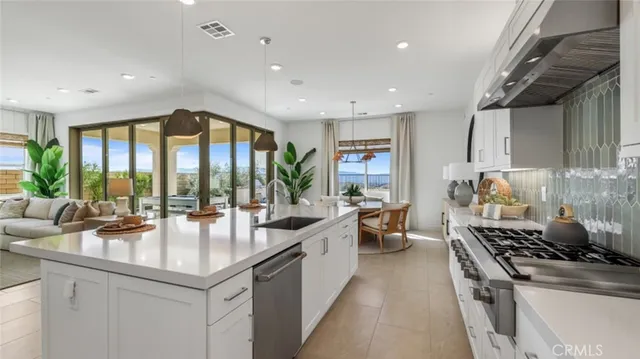 a large kitchen with stainless steel appliances a large window and a counter space