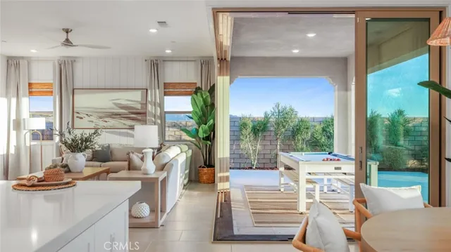 a living room with furniture a table and chairs