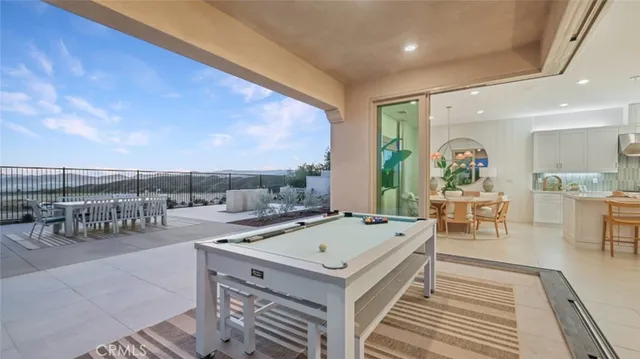 a view of a balcony with chairs and wooden floor