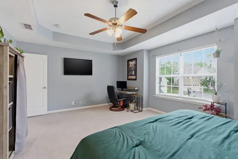 a bedroom with a bed and a large window
