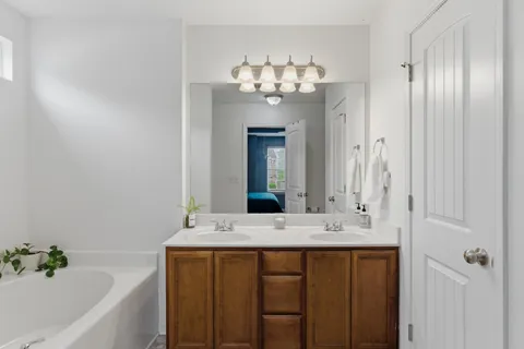 a bathroom with a double vanity sink and a mirror