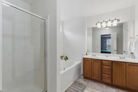 a bathroom with a tub sink and mirror
