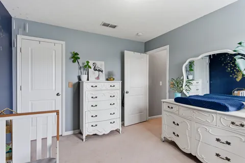 a view of walk in closet with clothes