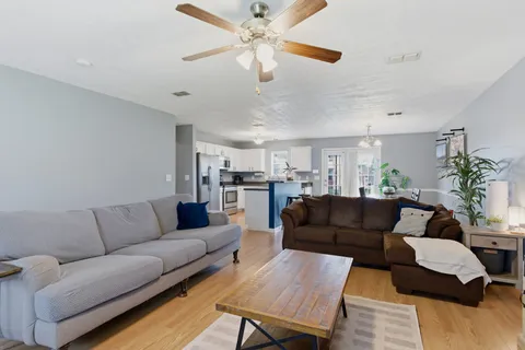 a living room with furniture and a chandelier