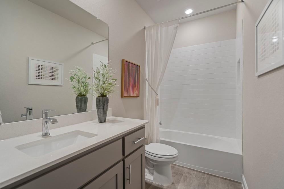 130 Hugo Court Rhome, TX 76078 - Photo 30 of 40 a bathroom with a sink a toilet and shower