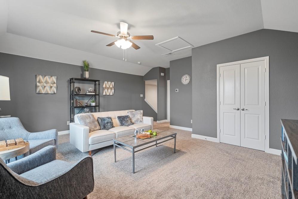 130 Hugo Court Rhome, TX 76078 - Photo 32 of 40 a living room with furniture and a chandelier