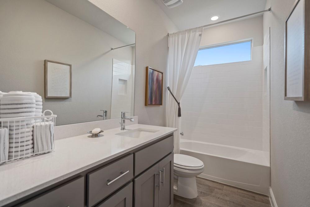 130 Hugo Court Rhome, TX 76078 - Photo 34 of 40 a bathroom with a sink a toilet and shower