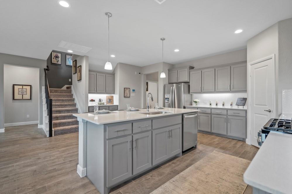 130 Hugo Court Rhome, TX 76078 - Photo 2 of 40 a kitchen with white cabinets and sink