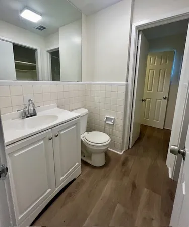 a bathroom with a toilet sink and mirror