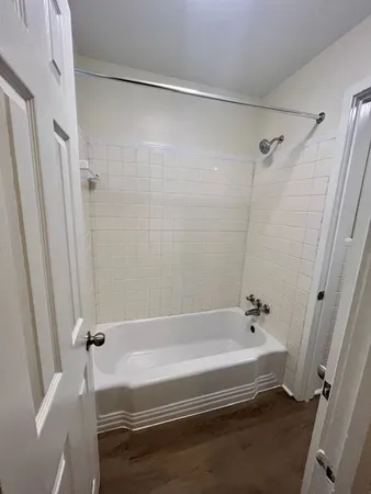 a bathroom with a bathtub and a shower