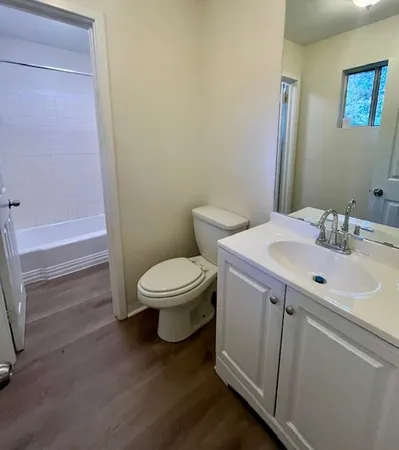 a white toilet sitting next to a bathroom sink