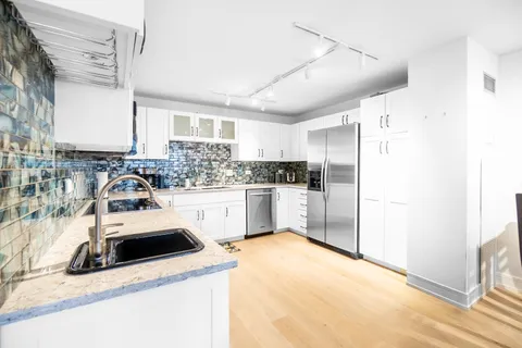 a kitchen with a sink a stove and refrigerator