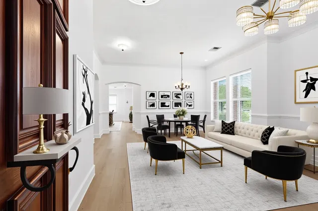 a living room with furniture and a chandelier