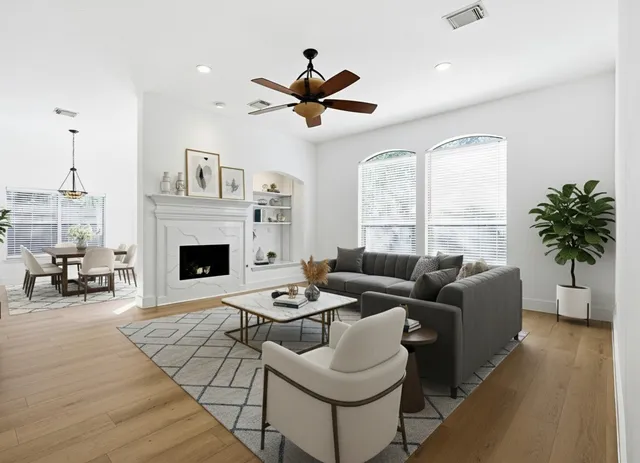 a living room with furniture fireplace and a large window