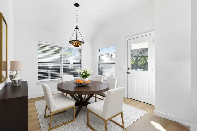 a living room with dining table and a window
