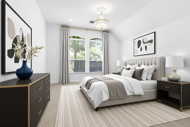 a bedroom with a large bed and a window