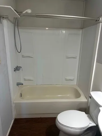 a bathroom with a white bath tub and a shower