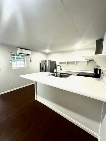 a kitchen with a refrigerator and a sink