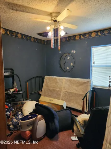a living room with furniture a window and a flat screen tv