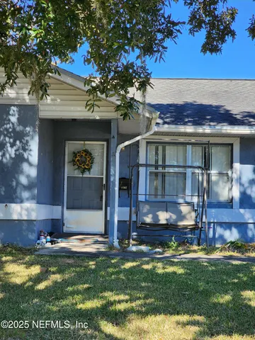 a view of house with yard