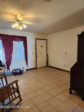 a view of a room with window and hardwood