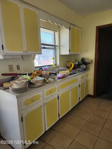 a kitchen with a sink a stove and a refrigerator